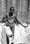An image of a young boy holding a skateboard