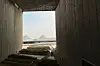 View of the Great Pyramids of Giza from the Grand Egyptian Museum, through a panorama window.