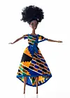 An image of a doll standing, dressed in African print