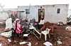 Residents prepare breakfast outside their destroyed house in the aftermath of a tornado and extreme weather at an informal settlement in Tongaat, north of Durban on June 04, 2024.
