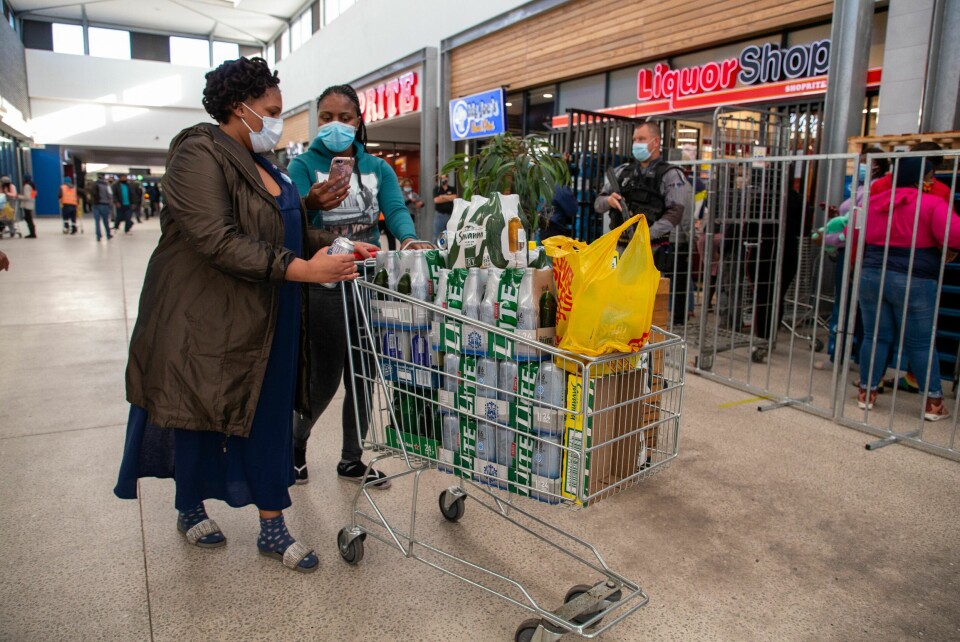 CAPE TOWN, SOUTH AFRICA - JUNE 01: A general view of people queuing and buying alcohol at Delft Mall on Day 66 of the National Lockdown on June 01, 2020 in Cape Town, South Africa. It is reported that liquor sales will be permitted under Level 3 regulations from 1 June. However, liquor would be allowed to be sold for home consumption only under strict conditions, on specified days and for limited hours. South Africans Panic Over Alleged Reinstatement of Alcohol Ban