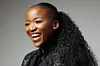 A photo of Ofentse Pitse wearing a black blouse and laughing.