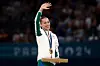 Gold medalist Kaylia Nemour of Team Algeria waves from the podium during the medal ceremony for the Artistic Gymnastics Women's Uneven Bars Final on day nine of the Olympic Games Paris 2024 at Bercy Arena on August 04, 2024 in Paris, France.