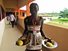 Woman serving foutou in Ivory Coast.
