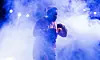South African rapper Sjava on stage in a puff of smoke.