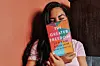 Alya Mooro holding her non-fiction bestseller \u2018The Greater Freedom.\u2019