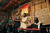 Members of Negarit Band play saxophones, keyboard, and traditional instruments on stage at Boiler Room\u2019s first event in Addis Ababa, beneath a colorful woven ceiling.
