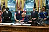 Trump signs a letter in the Oval Office ceremony with Congo Foreign Minister Therese Kayikwamba Wagner, Rwandan Foreign Minister Olivier Nduhungirehe, US Vice President JD Vance, and US Secretary of State Marco Rubio looking on.