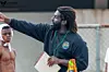 A photo of Asante Sefa-Boakye, a Black man with tied-back dreadlocks and a healthy beard, during water polo training.