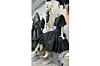 A photo of David Tlale\u2019s pieces - a black gown - on a mannequin.