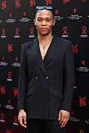 A photo of South African designer Thebe Magugu in a black suit at the 'Annees Palace' - 20th 'Diner De La Mode' as part of Paris Fashion Week at Pavillon Cambon Capucines on July 06, 2023 in Paris, France.