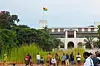 An image of people standing outside the art gallery, with the Togo flag waving from the top of the building.