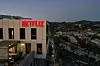 Close up shot of the Netflix logo on top of their office building.