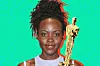 Lupita Nyong’o smiling in front of a bright green graphic background with an Oscar statuette superimposed beside her.