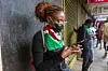 A photo of a Kenyan protester using a smartphone during anti-corruption demonstrations.
