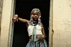 Kenyan artist Elsy Wameyo stands on a doorstep in the music video for her single “Conquer.”