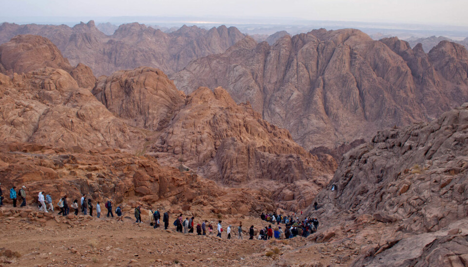 A group of tourists on the way down Egypt’s Mount Sinai after the night ascent to admire the sunrise in November 2010. A group of tourists on the way down Egypt’s Mount Sinai, with a view of the mountain ranges in front of them.