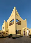 A two-story building with curved facades and patterned cutouts, known as Wave House in Hargeisa, Somaliland.
