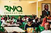 A wide shot of people sitting inside the RNAQ Food bank branch in Kasoa