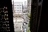View of a decaying street in Cairo through an arabesque window.