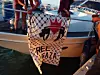 Volunteers hand a banner on a boat with the inscription, “Free Gaza.”