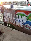 Gaza-bound boat showing a banner with inscription “Never Again For Anyone.”
