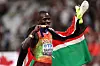 Gold medalist, Emmanuel Wanyonyi of Team Kenya, bites the medal whilst wearing the national flag after winning the gold medal in the Men's 800 Metres Final on day eight of the World Athletics Championships Tokyo 2025 at National Stadium on September 20, 2025 in Tokyo, Japan.