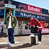 The cover for Shakes & Les’ latest offering. They pose in front of a convenience store titled Estradini, the name of their album. One half is holding a pay phone while the other rests his foot on a black crate.