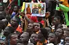 A man holds a placard with the image of Niger's new military ruler General Abdourahamane Tiani on as supporters of Niger's National Council of Safeguard of the Homeland (CNSP) protest outside the Niger and French airbase in Niamey on September 2, 2023 to demand the departure of the French army from Niger.