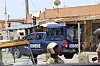 A blue Togolese Gendarmerie truck is seen on the street at a stoplight.