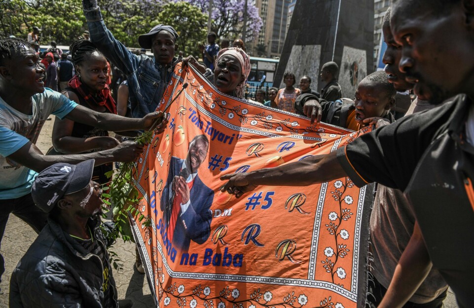 Hundreds of people took to the streets to pay tribute to Kenya's former Prime Minister and opposition leader, Raila Odinga, who passed away today, Wednesday, October 15, 2025. A crying woman holds up a banner with Raila Odinga’s picture, while others surround her and point at the banner.