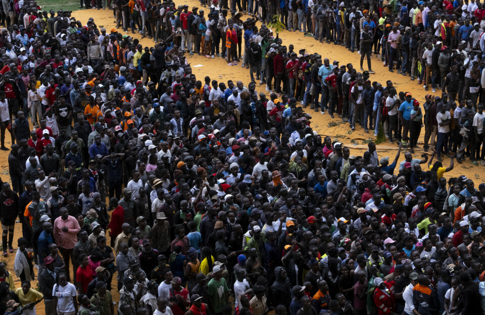 Thousands of supporters and mourners of the late Kenyan opposition leader Raila Odinga gather ahead of the public viewing of his coffin at the Kasarani Stadium in Nairobi on October 16, 2025. Thousands of people are lined up in groups.