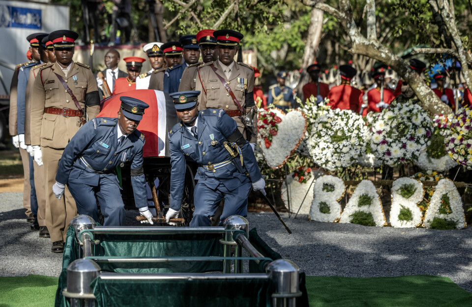 Senior military officials carry the coffin of Kenya's former Prime Minister Raila Odinga past floral wreaths reading 'Baba', meaning 'father' in Swahili and Odinga's popular nickname, during his burial ceremony in Bondo, on October 19, 2025. Military officials serving as pallbearers carry Raila Odinga’s coffin past floral wreaths reading “Baba.”