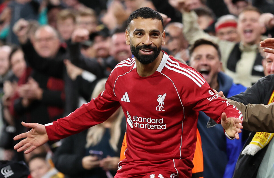 Egypt’s Mohamed Salah, who plays for Liverpool and is this year’s Premier League Golden Boot winner, is one of 10 footballers shortlisted for the 2025 CAF African Footballer of the Year Award. Mohamed Salah, in the red and white Liverpool jersey, celebrates, arms spread out and smiling, with a stadium of supporters behind him.