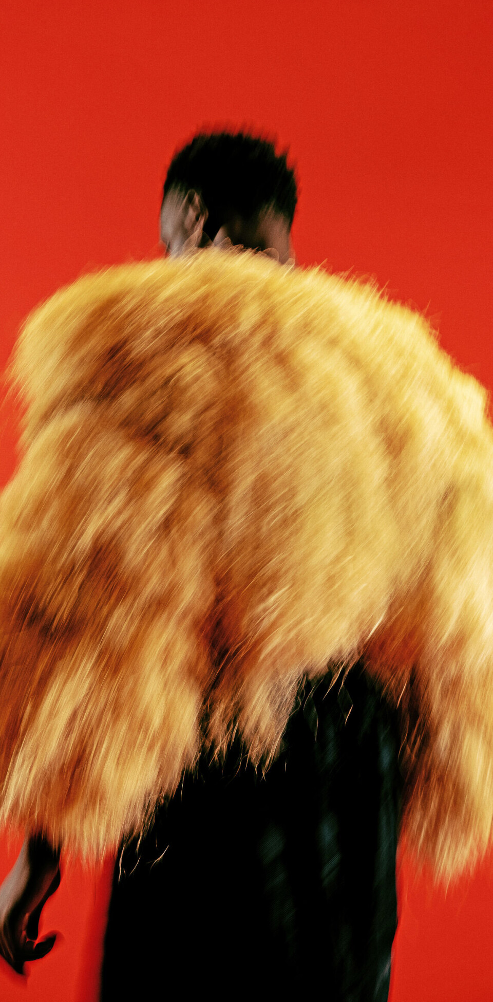 Joaloso says it was crucial to immortalize these stories in an age where attention is fleeting and fashion photography is tied to hyper-consumerism. A blurry shot of a man wearing a feather jacket in front of a red background