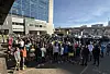 A large crowd of runners stands outside a modern office building in Nairobi’s Westlands area.