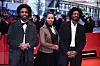 Rawia Alhag (M), director, Ibrahim Snoopy (R), director, and Timeea M Ahmed, director, of the film Khartoum walk the red carpet for the award ceremony of the closing gala at the Berlinale Palast.