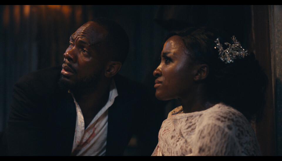 The Herd tackles Nigeria’s insecurity problem with heart, tenderness and blistering critique on the country’s dysfunctional system. A still from the Nigerian film The Herd featuring a man in a suit and a woman wearing a wedding gown.