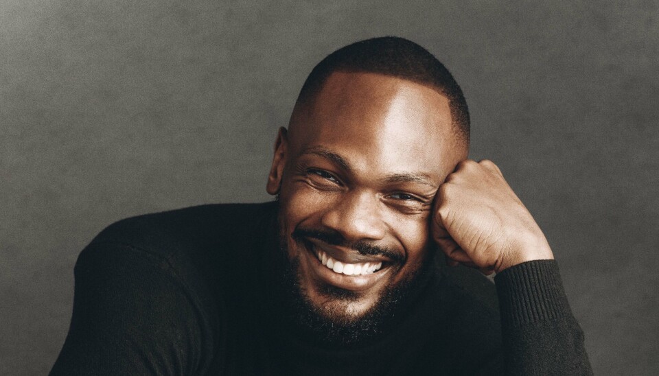 Daniel Etim Effiong has always taken risks, plunging headfirst into acting and now making his directorial feature debut. A portrait shot of Daniel Etim Effiong behind a black background