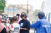 Musa Omusi smiles while talking with a small group of people on a street in Ngara.