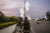 Two young men pose for a photograph in front of the newly installed Christmas city lights in Cotonou.