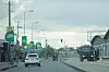 An electoral poster of Tanzania's President Samia Suluhu Hassan is seen as police officers inspect vehicles at a deserted intersection in Dar Es Salaam.