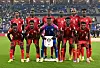 Players of Sudan pose for a team photograph before the FIFA Arab Cup 2025, wearing red jerseys.