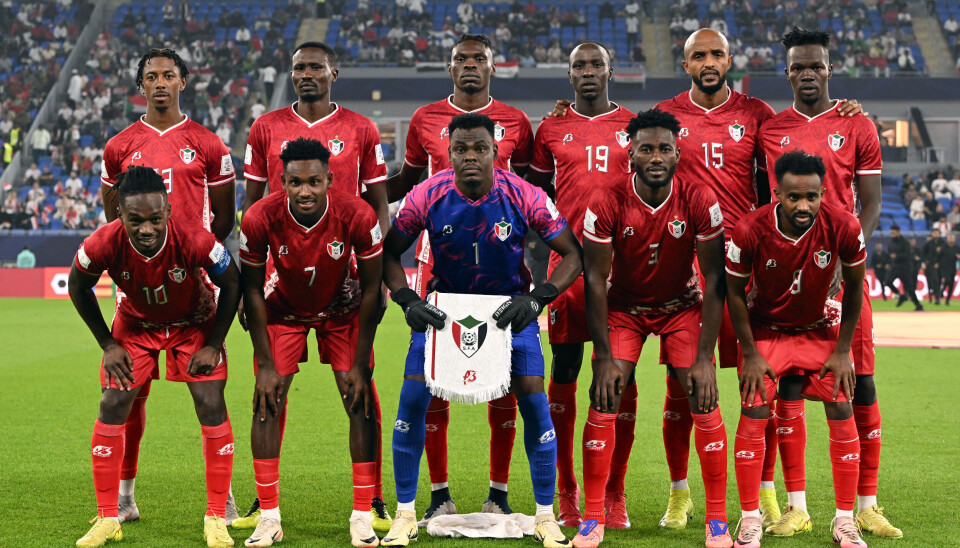 'Every time the national anthem plays during a game, you can see that every player is emotional. This demonstrates how much each player cares about playing well and giving it their all to restore happiness to our people.' - Abdelrahman Kuku, Sudan national team defender. Players of Sudan pose for a team photograph before the FIFA Arab Cup 2025, wearing red jerseys.