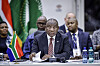 President Cyril Ramaphosa speaks at a table during a working dinner at the Sandton Convention Centre.