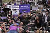 Women dressed in black take part in a demonstration against gender-based violence and the rising number of femicides, holding placards denouncing violence against women.