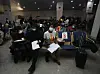 ​A group of Nigerian students fill out their data at Nnamdi Azikiwe airport.