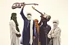 Five men wearing traditional Tuareg attire and turbans are standing in front of a white background, looking directly into the camera. Two of them are holding electric guitars over their heads.