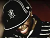 The cover artwork for J Dilla’s 2006 album, Donuts, shows J Dilla smiling with his head down and a baseball cap over his eyes.