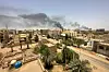 Smoke rises between buildings after clashes erupted in the Sudanese capital between the Sudanese Armed Forces and the paramilitary Rapid Support Forces (RSF).